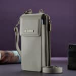 Beige leather mobile phone pouch with a shoulder strap; elegant design, practical fashion accessory.